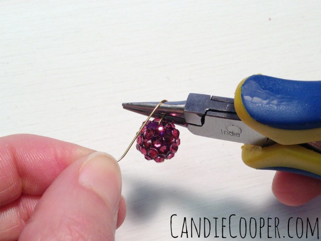 Wrap the wire over the top of the pliers and around the top of the bead